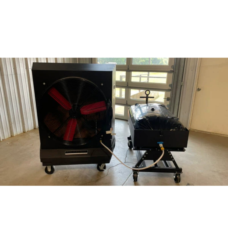 Black PolarCool Pro 36 evaporative cooler attached via hose to Water Cart, both on wheels, in a room with a garage door.
